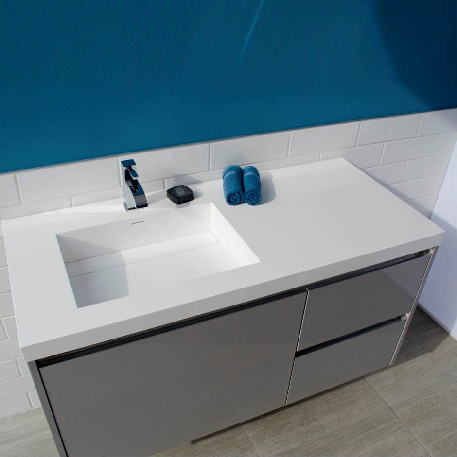 Neenan Company ShowroomLacavaVanity-top Bathroom Sink made of solid surface, with an overflow and decorative drain cover.